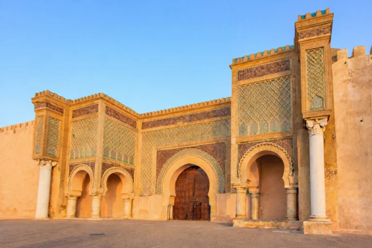 Bab Mansour gate in Meknes, Morocco, with ornate geometric tilework and grand arched entrances